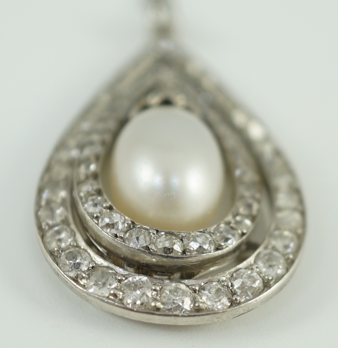 An early 20th century platinum, cultured? pearl and diamond cluster set pear shaped drop pendant necklace